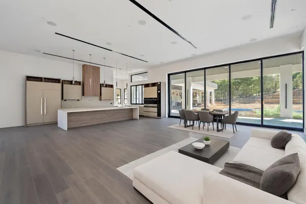 a living room with furniture and large windows