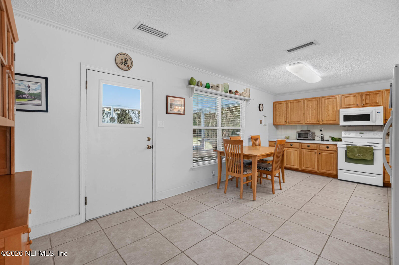 1950 Lightsey Road St. Augustine, FL 32084 - Photo 15 of 57 a kitchen with a cabinets and chairs