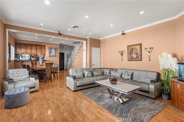 a living room with furniture and view of kitchen