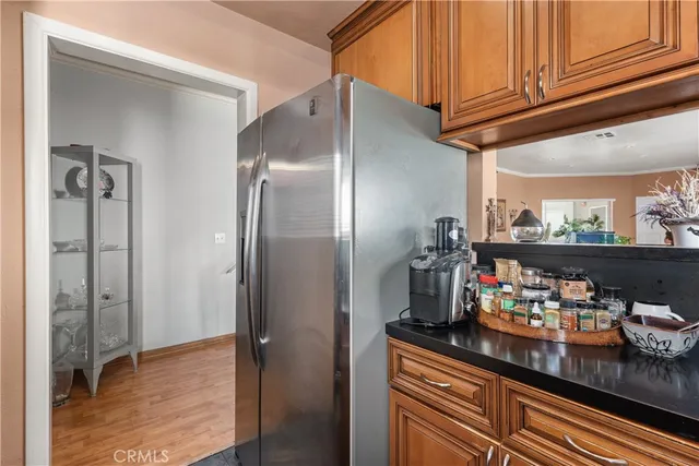 a kitchen with refrigerator and cabinets