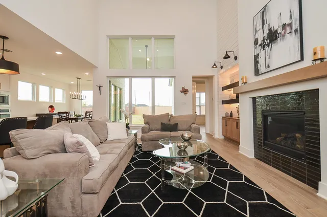 a living room with furniture a rug and a chandelier