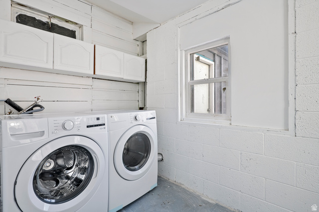75 600 West Provo, UT 84601 - Photo 19 of 26 Dedicated laundry area featuring a white front-load washer and dryer set, white upper cabinetry, and a white-framed window