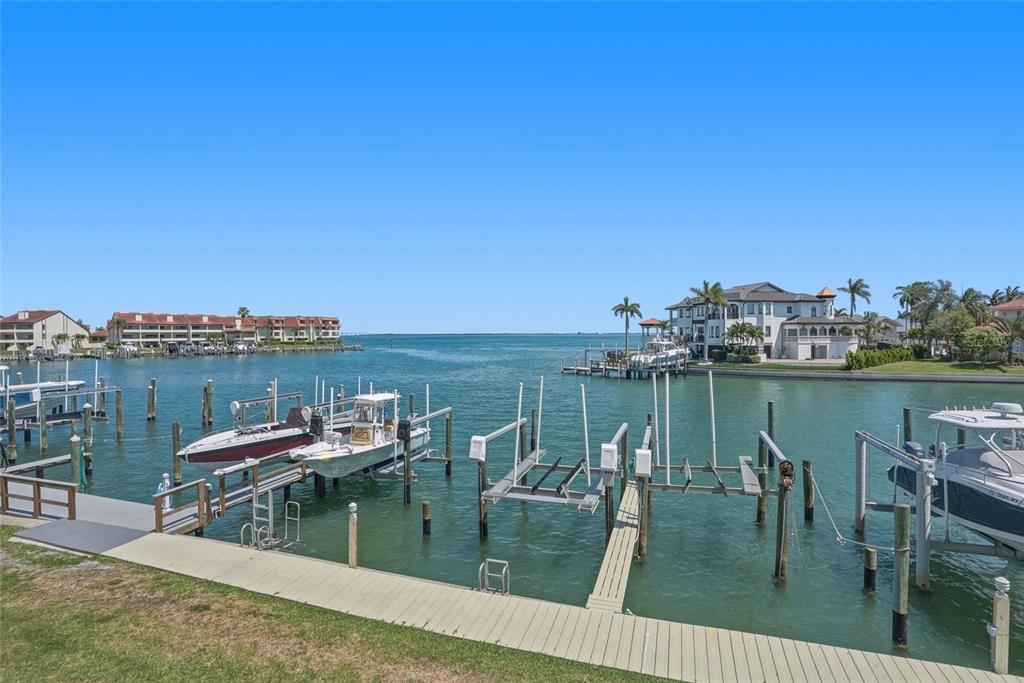 363 Pinellas Bayway South, Unit 29 Tierra Verde, FL 33715 - Photo 34 of 59 a view of a lake with a bench and trees in the background