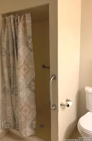 a bathroom with a shower curtain