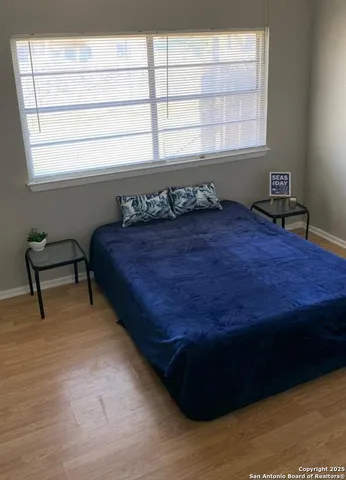 a bed sitting in a bedroom next to a window