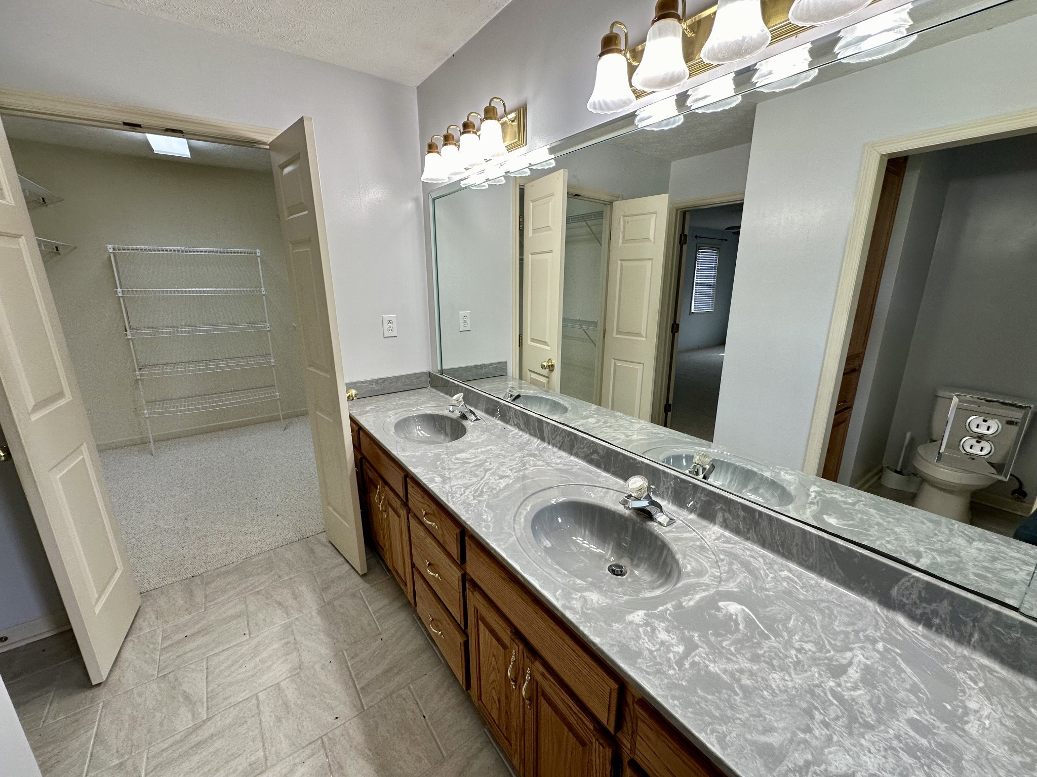 654 Denning Ford Road Portland, TN 37148 - Photo 20 of 39 a bathroom with a granite countertop sink a large mirror and a shower