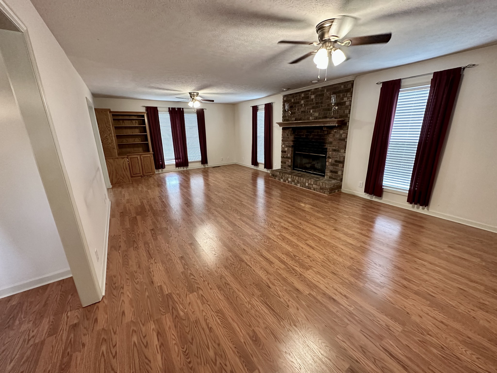 654 Denning Ford Road Portland, TN 37148 - Photo 6 of 39 wooden floor in an empty room with a fireplace