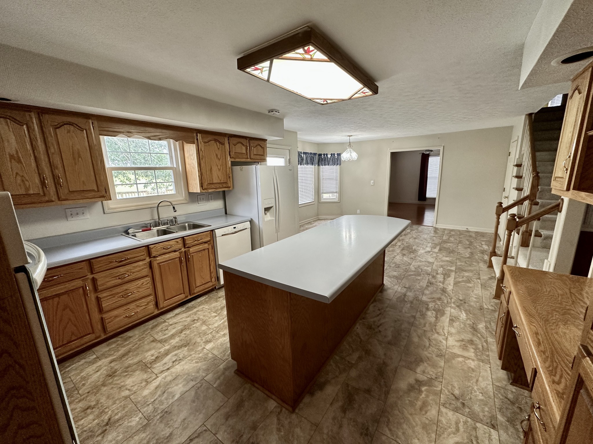 654 Denning Ford Road Portland, TN 37148 - Photo 9 of 39 a kitchen with a stove a sink and a refrigerator