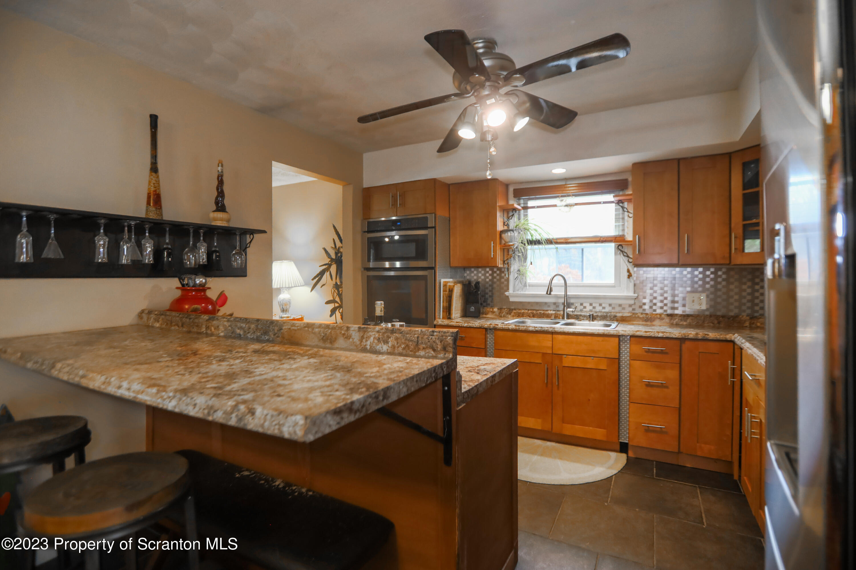 740 Weavertown Road Shavertown, PA 18708 - Photo 31 of 82 a kitchen with stainless steel appliances granite countertop a sink a stove and a wooden cabinets