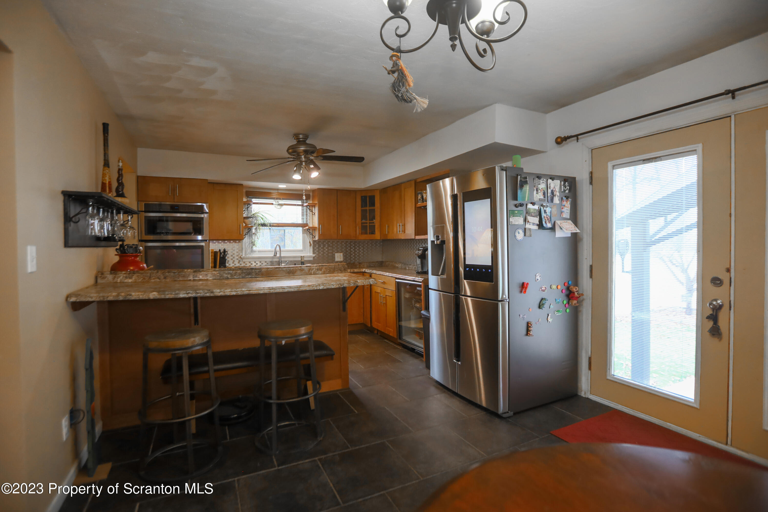 740 Weavertown Road Shavertown, PA 18708 - Photo 56 of 82 a kitchen with stainless steel appliances granite countertop a refrigerator a sink dishwasher a stove and a dining table with wooden floor