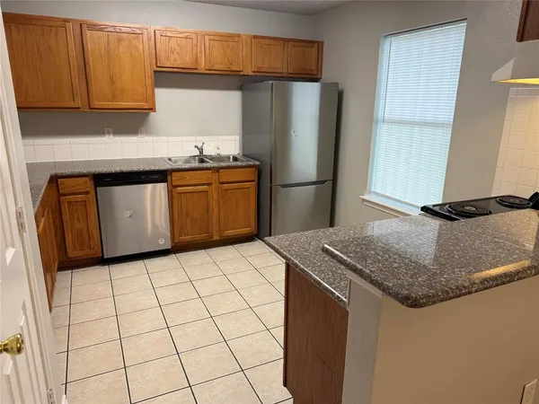 a kitchen with stainless steel appliances granite countertop a refrigerator sink and cabinets