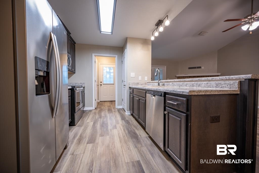 15874 Carver Road, Unit C Foley, AL 36535 - Photo 10 of 18 Kitchen featuring dark brown cabinets, ceiling fan, stainless steel appliances, sink, and light hardwood / wood-style flooring