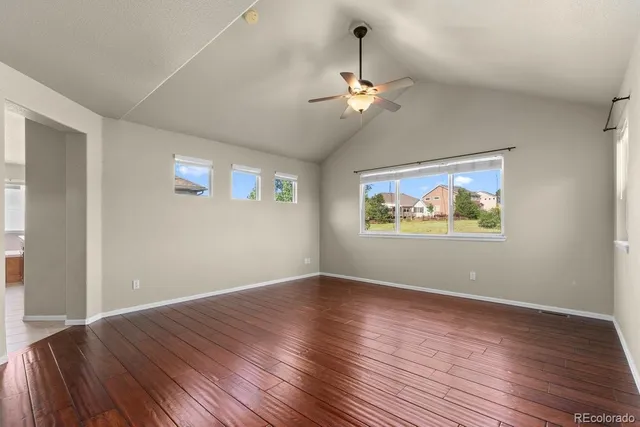 a view of wooden floor chandelier and window in a room