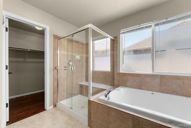 a bathroom with a bathtub and a shower