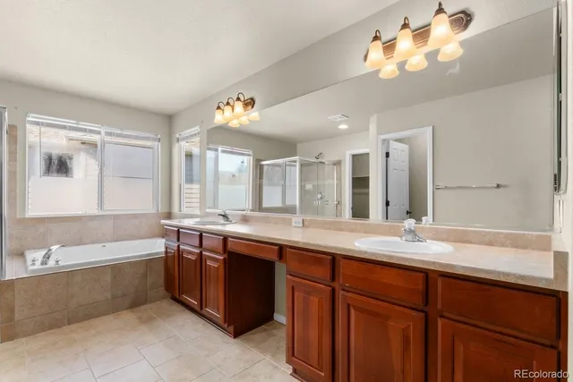 a large bathroom with a double vanity sink and a mirror