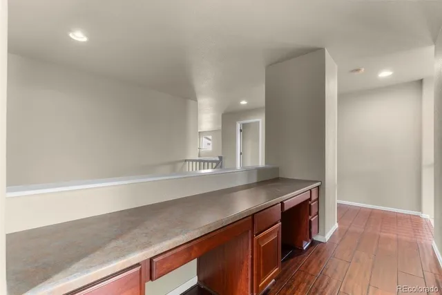 a room with a wooden floor and a sink