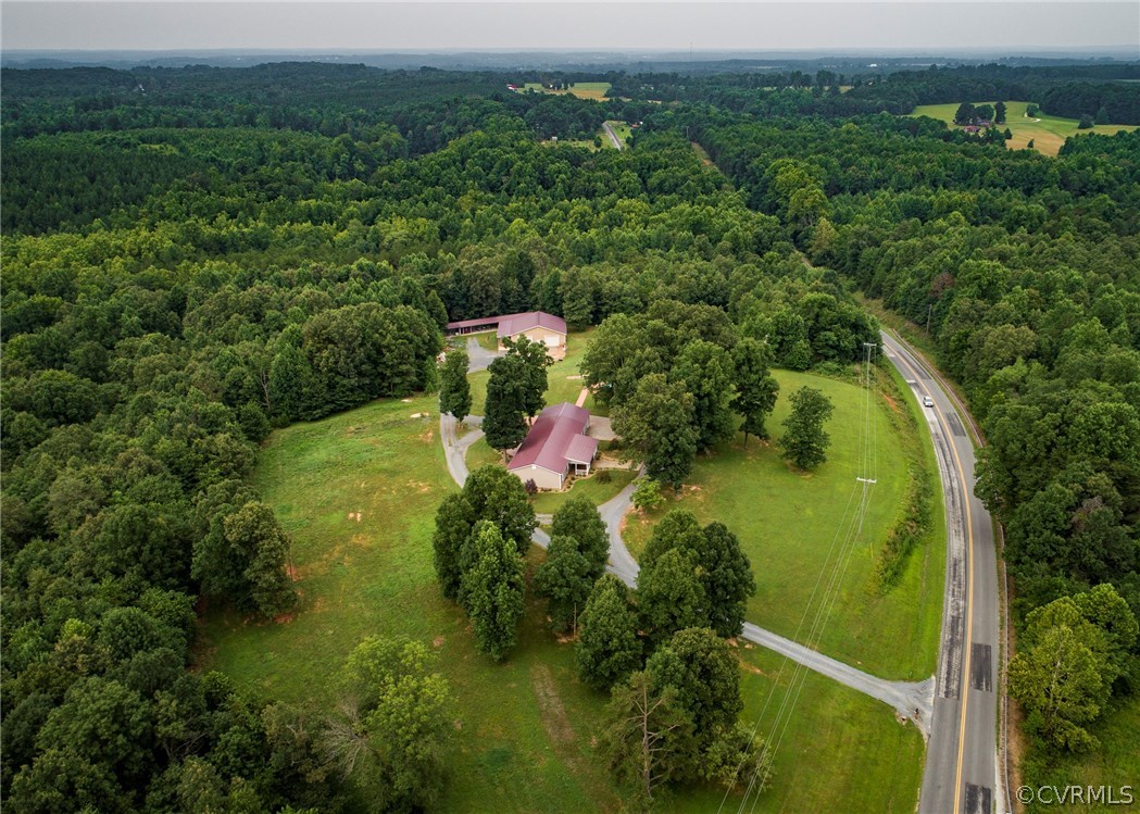 an aerial view of a house with a yard