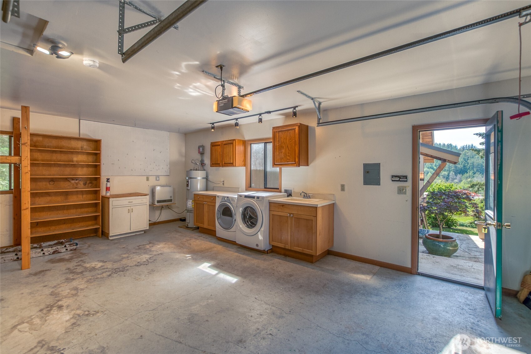402 Cayou Valley Road Orcas Island, WA 98245 - Photo 9 of 40 a utility room with cabinets dryer and washer