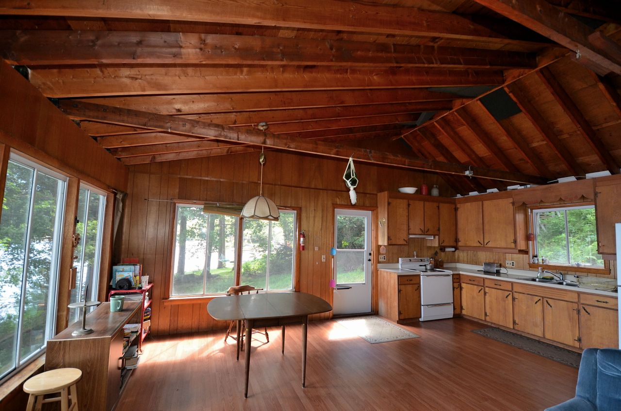 405 Stanley Road Otis, MA 01029 - Photo 11 of 16 a open kitchen with granite countertop a stove sink and refrigerator