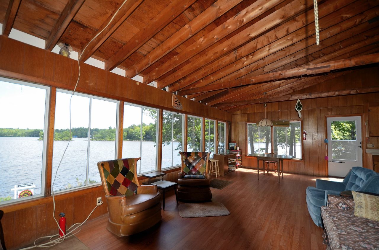 405 Stanley Road Otis, MA 01029 - Photo 10 of 16 a living room with furniture a wooden floor and a large window