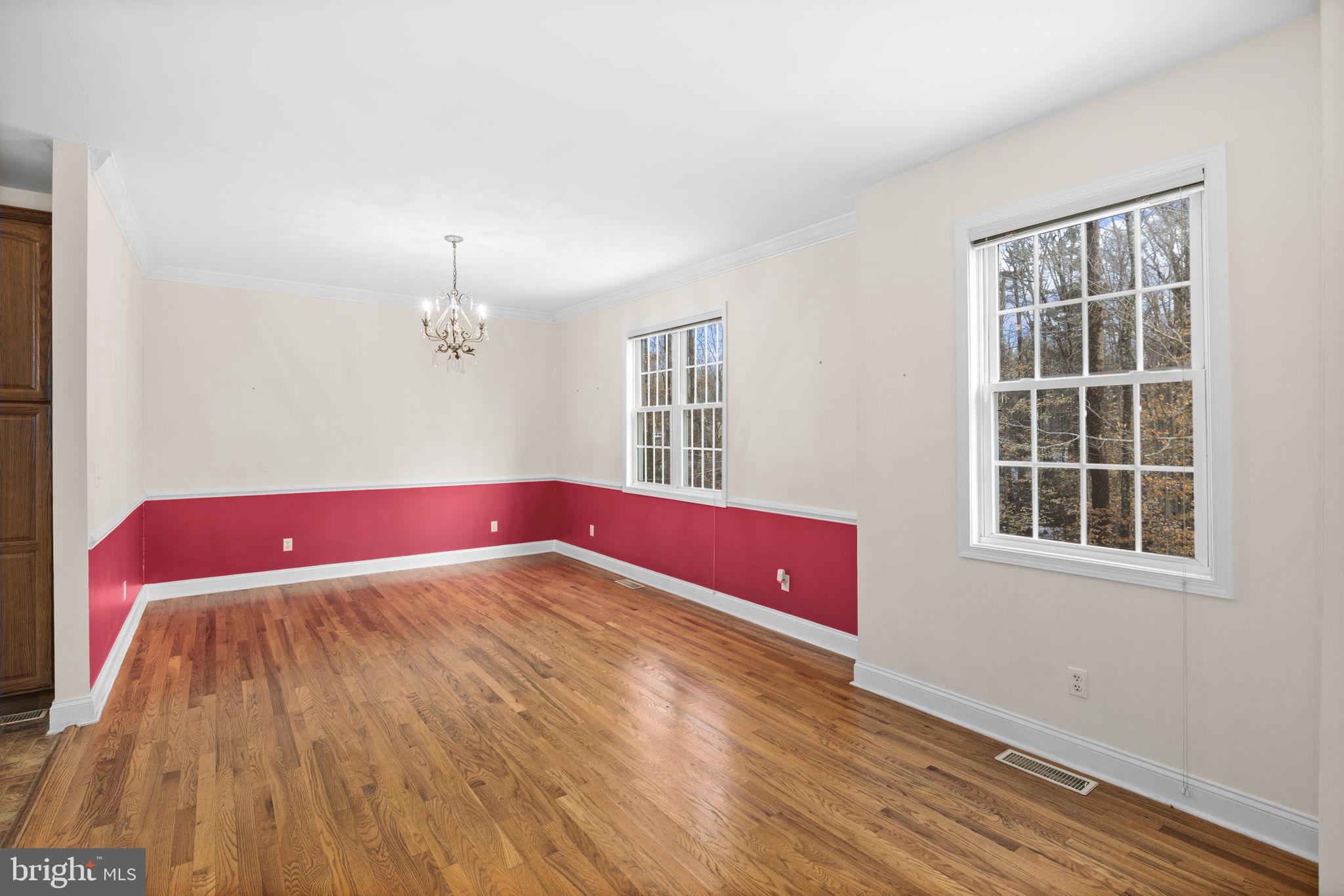 2481 Yanceyville Road Louisa, VA 23093 - Photo 13 of 66 a view of an empty room with wooden floor and a window