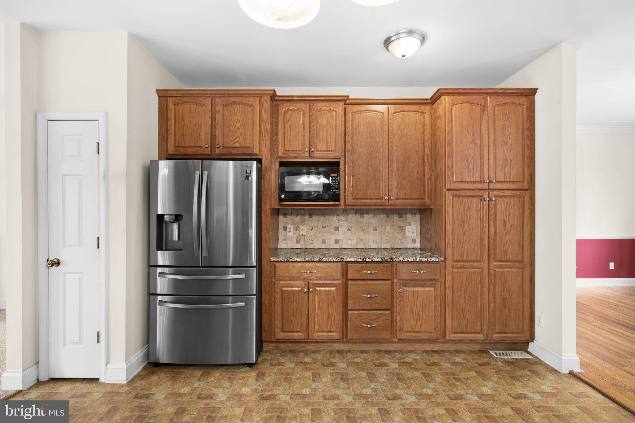 2481 Yanceyville Road Louisa, VA 23093 - Photo 18 of 66 a kitchen with stainless steel appliances granite countertop a refrigerator and a stove top oven