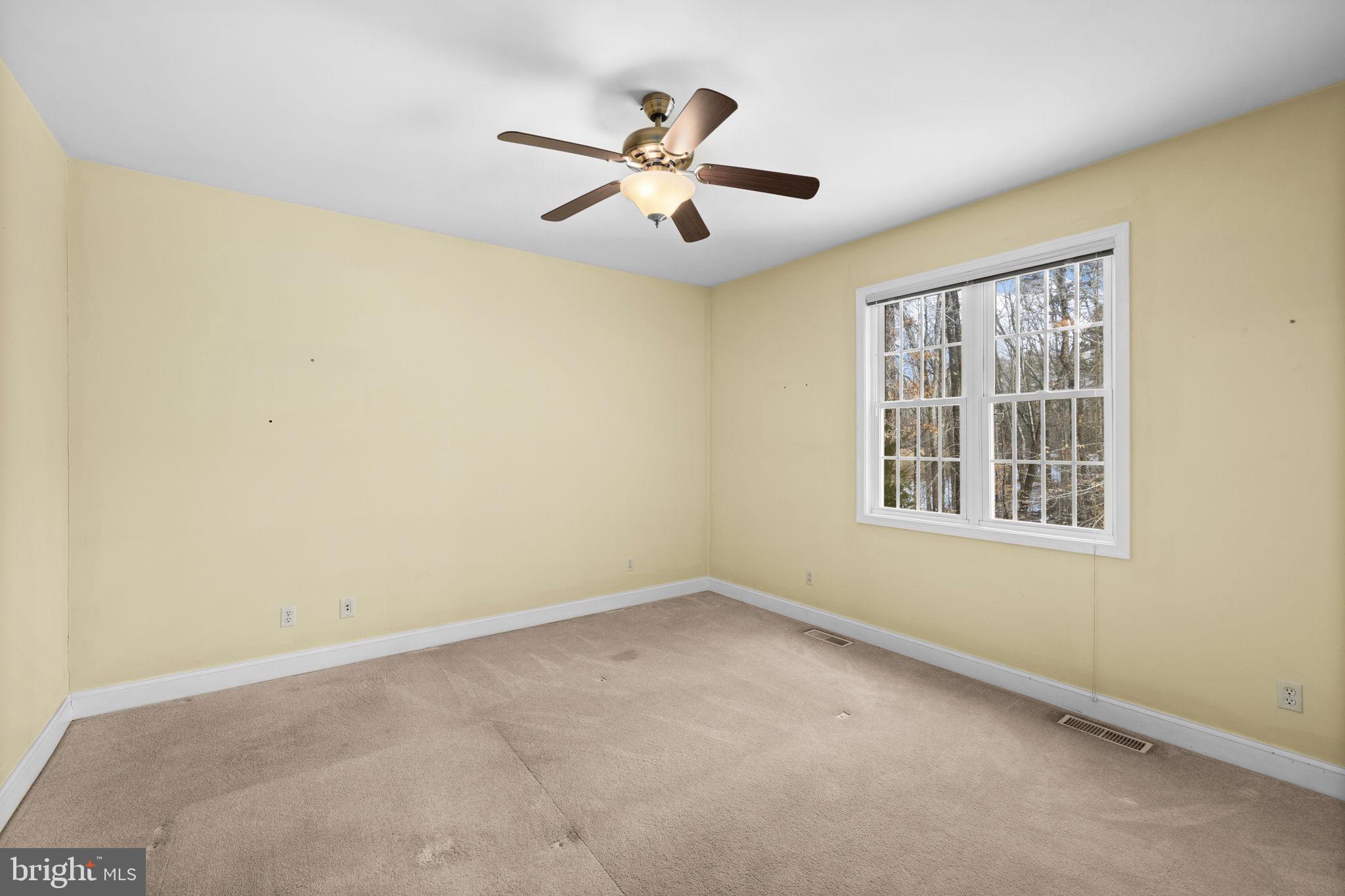 2481 Yanceyville Road Louisa, VA 23093 - Photo 32 of 66 an empty room with window and ceiling fan
