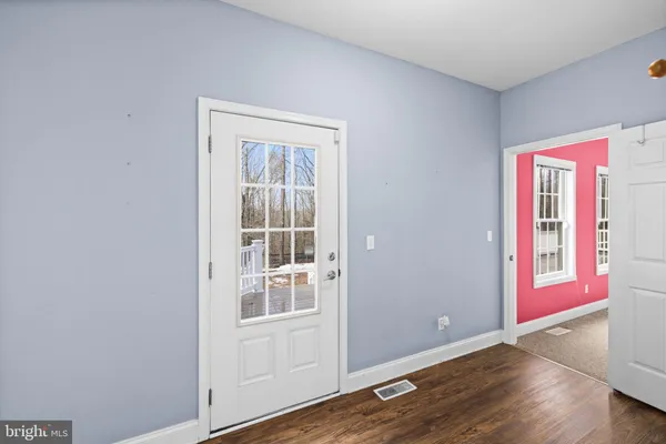 a view of a livingroom with a ceiling fan and entryway