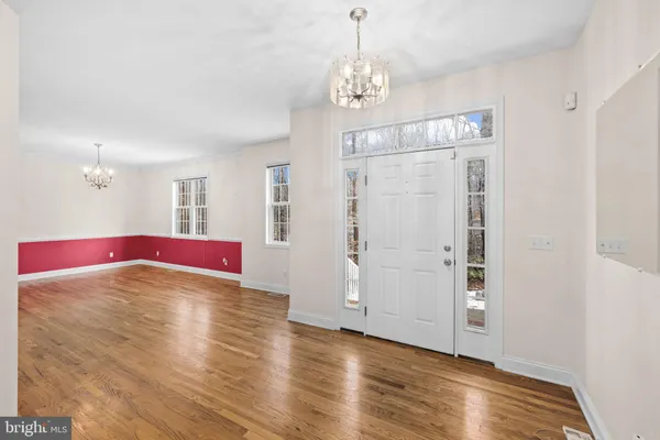 a view of a room with wooden floor and windows