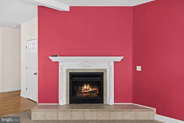a view of an empty room with a fireplace