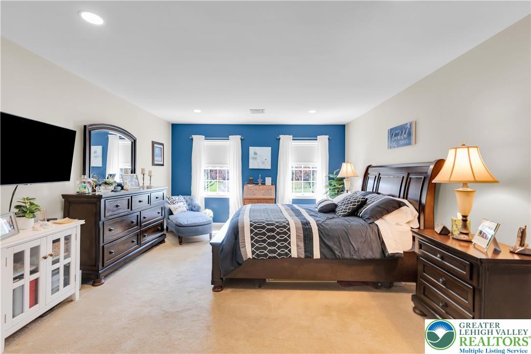 4059 Old Sentry Road Allentown, PA 18104 - Photo 16 of 39 Recessed lighting illuminates this inviting bedroom, featuring twin windows that offer natural light.