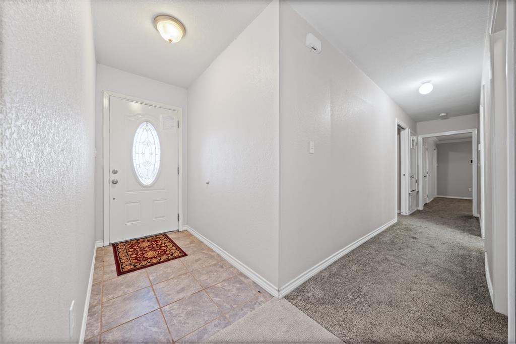 891 HCR 2124 Loop Whitney, TX 76692 - Photo 17 of 40 an empty room with mirror and a mirror