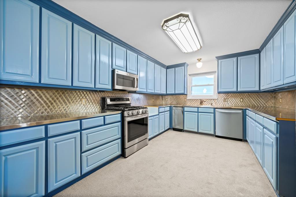 891 HCR 2124 Loop Whitney, TX 76692 - Photo 19 of 40 a kitchen with granite countertop a stove cabinets and window