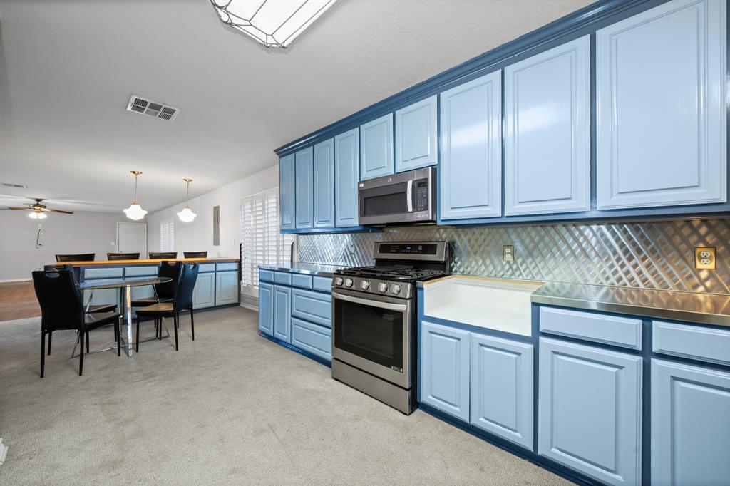 891 HCR 2124 Loop Whitney, TX 76692 - Photo 20 of 40 a kitchen with kitchen island granite countertop a stove top oven a sink a dining table and chairs