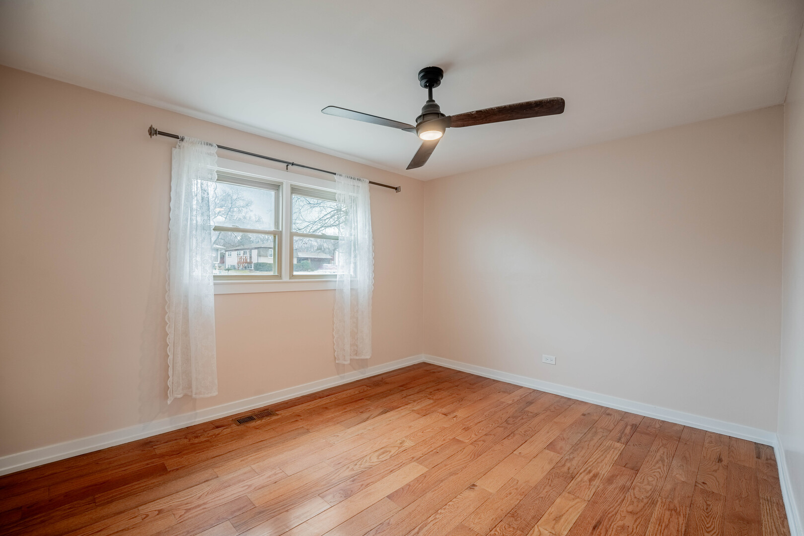 309 Falconridge Way Bolingbrook, IL 60440 - Photo 15 of 34 an empty room with wooden floor ceiling fan and windows