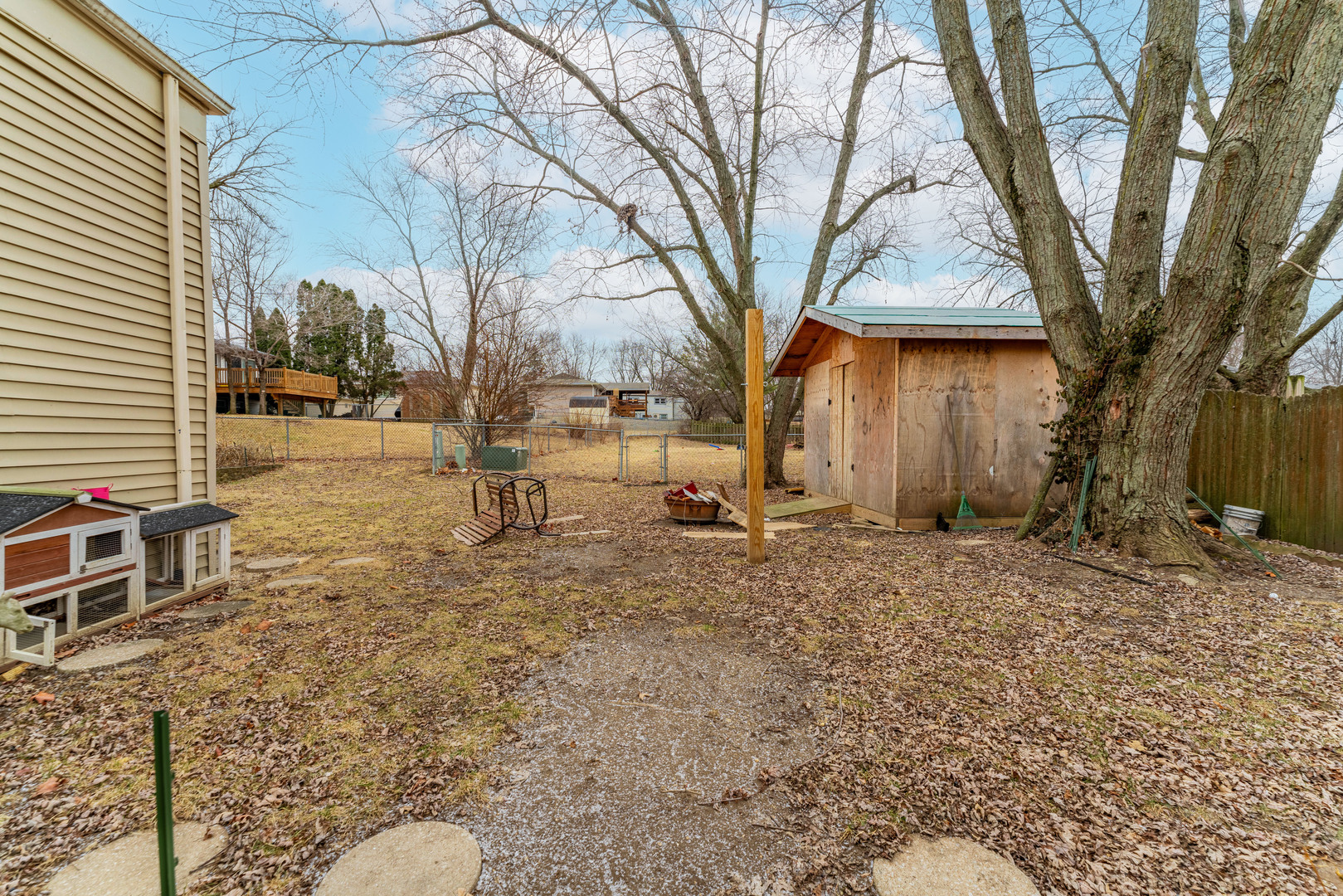 309 Falconridge Way Bolingbrook, IL 60440 - Photo 30 of 34 a backyard of a house with large trees and outdoor seating