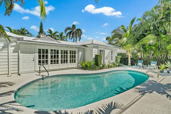 a view of a house with a backyard and plants