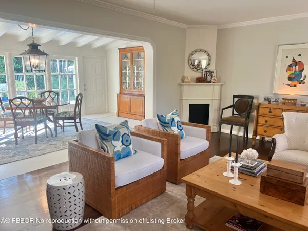 a living room with furniture a fireplace and a large window