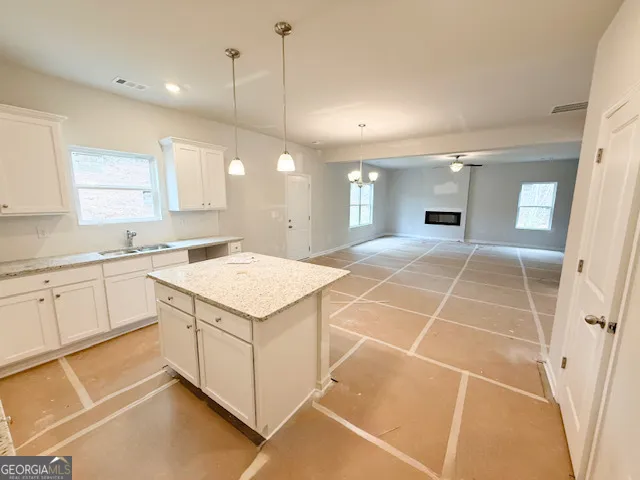 a kitchen with a sink cabinets and window