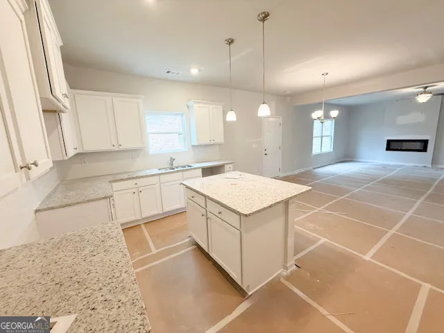 a kitchen with a sink cabinets and window