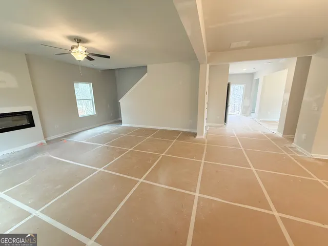 a room with a white walls and chandelier