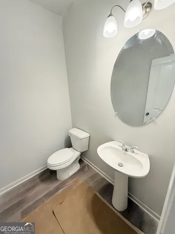 a bathroom with a sink a mirror and a toilet