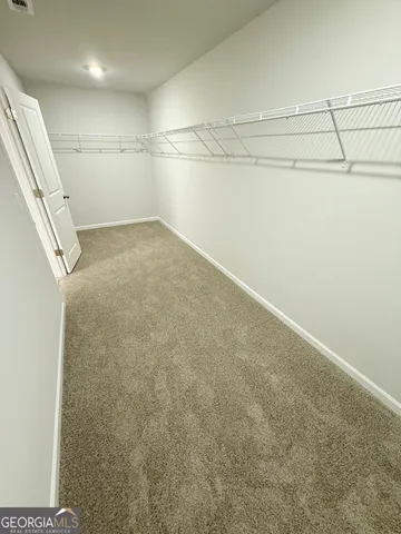 a white toilet sitting next to a white wall