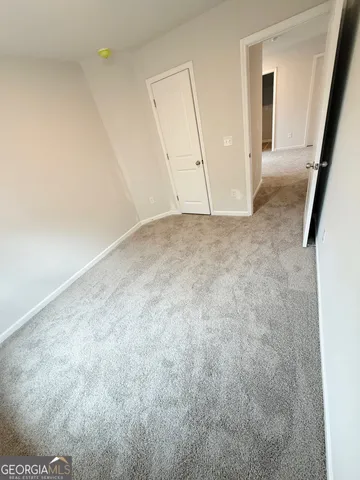 a bathroom with a granite countertop sink a toilet a mirror and bathtub