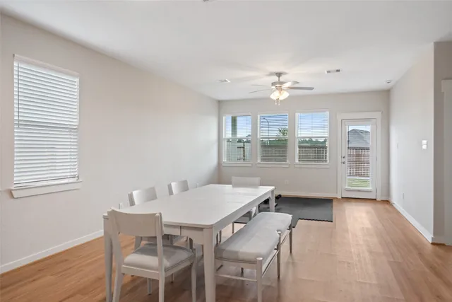 a view of a dining room with furniture window and wooden floor