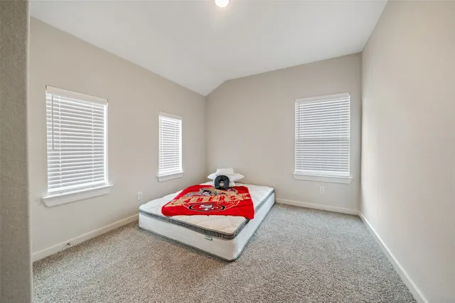 a bedroom with a bed and window