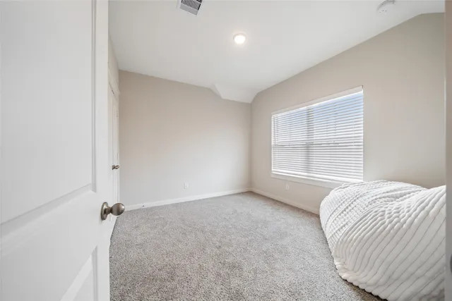 a view of a bedroom with a large bed and a window