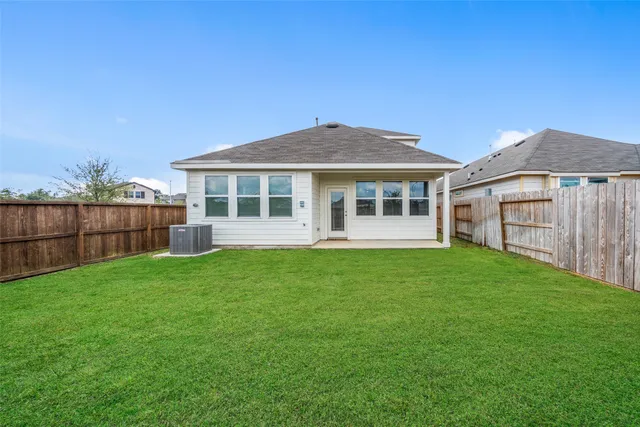 a view of a house with a backyard
