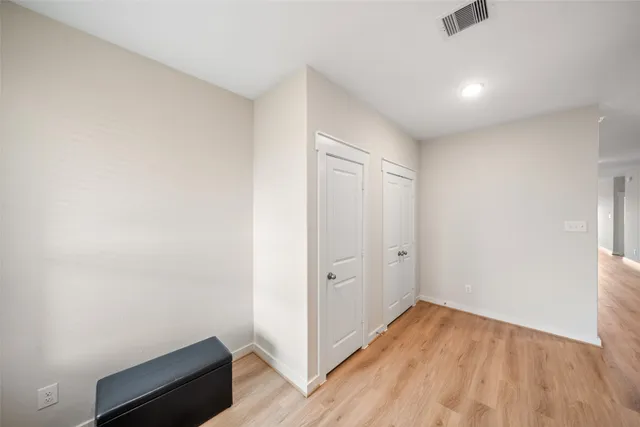 an empty room with wooden floor