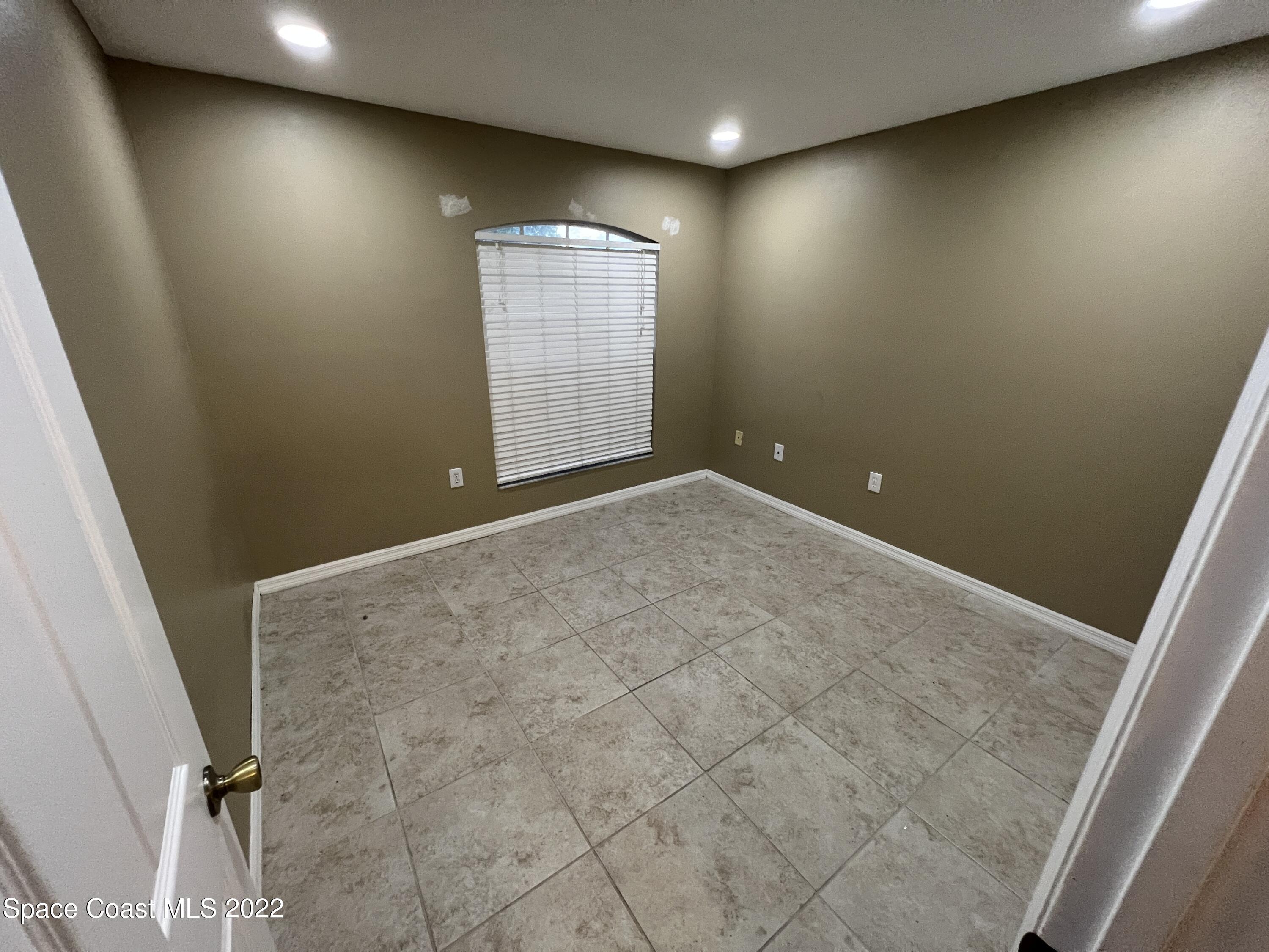 1873 Cleveland Street Northeast Palm Bay, FL 32905 - Photo 19 of 28 en empty room with windows